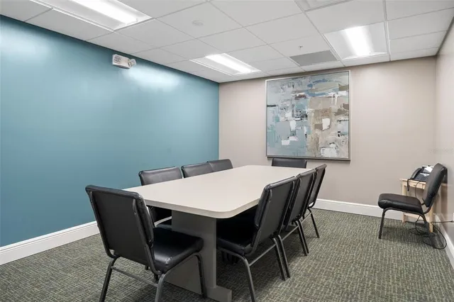 a room with pool table and windows