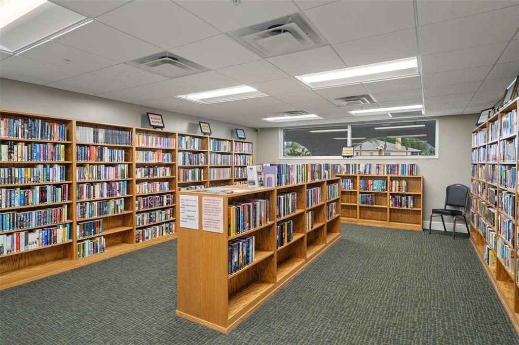 11630 Bayonet Lane New Port Richey, FL 34654 - Photo 50 of 58 a room with lots of furniture and a book shelf