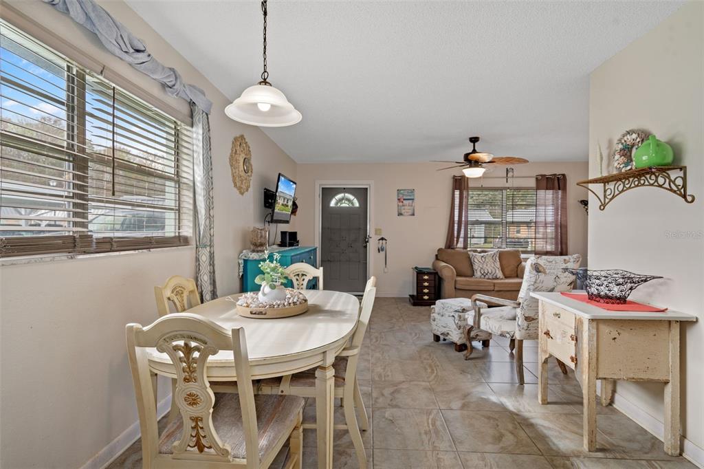 11630 Bayonet Lane New Port Richey, FL 34654 - Photo 9 of 58 a view of a dining room with furniture and a chandelier