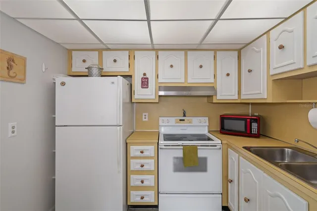 a kitchen with stainless steel appliances granite countertop a sink a stove and cabinets