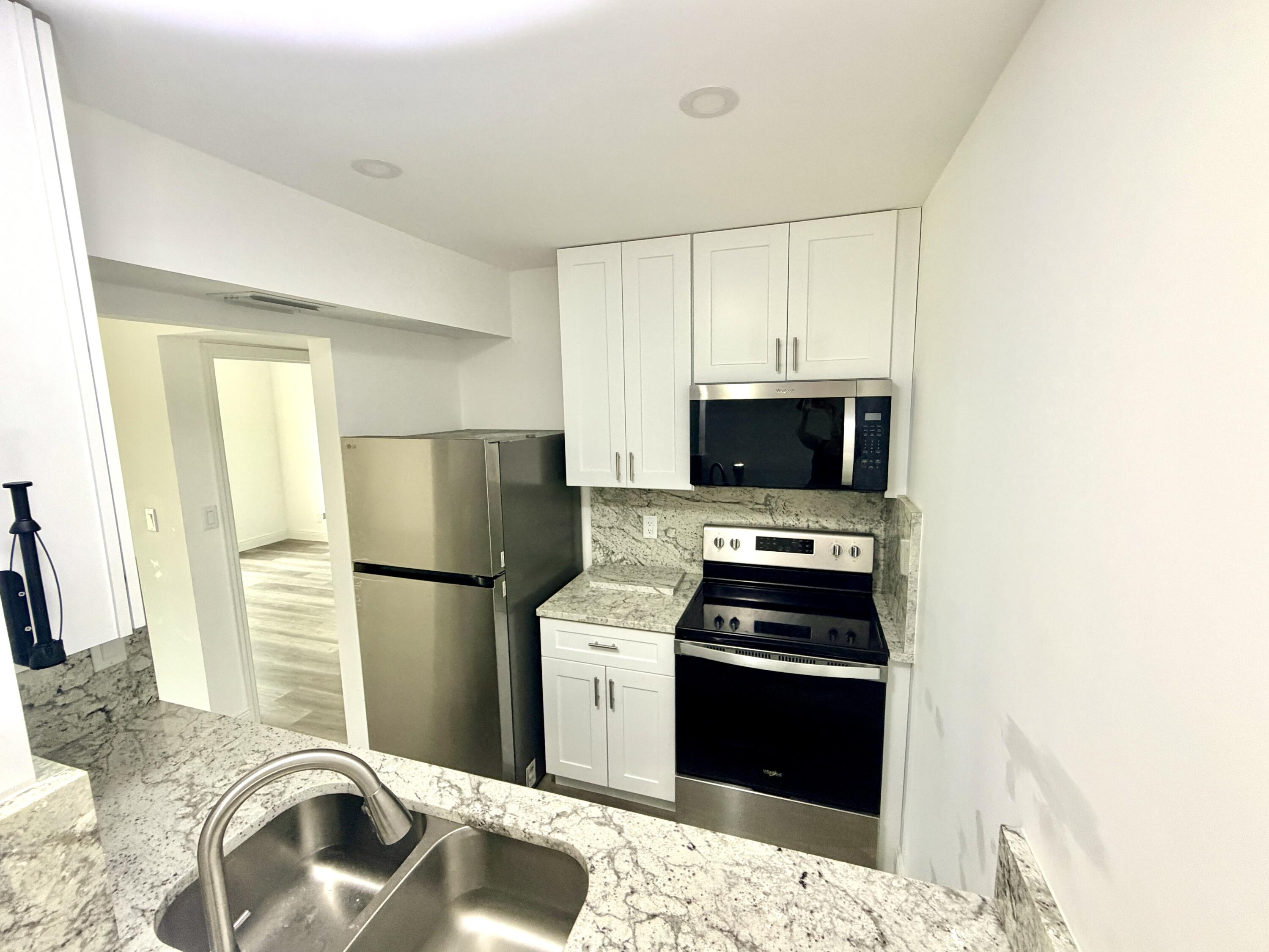 1766 Abbey Road, Unit 105 West Palm Beach, FL 33415 - Photo 1 of 8 ___F105 kitchen 1