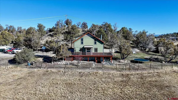 a view of a house with a yard and sitting area