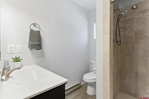 a bathroom with a sink toilet and shower