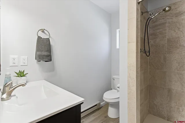 a bathroom with a sink toilet and shower