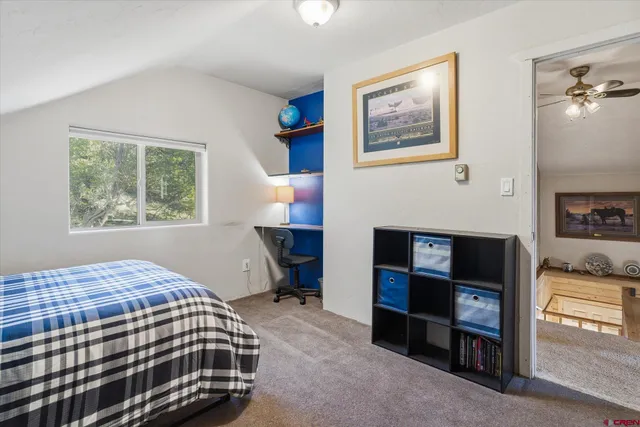 a bedroom with a bed and a fireplace