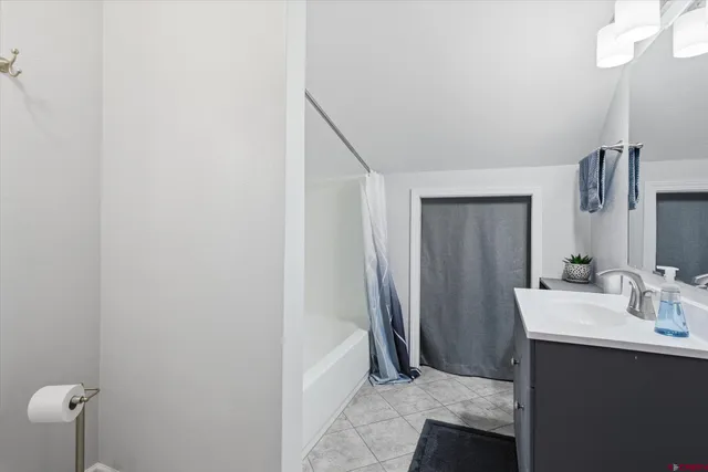 a bathroom with a sink a mirror and shower