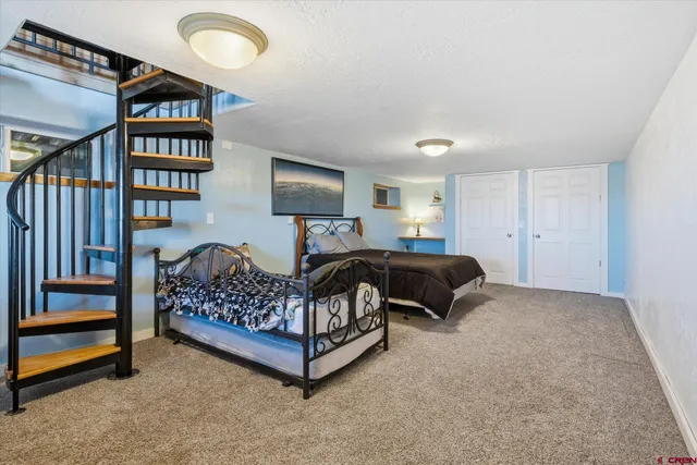 a bedroom with bed and a book shelf