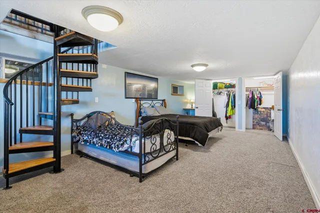 a bedroom with bed and a book shelf