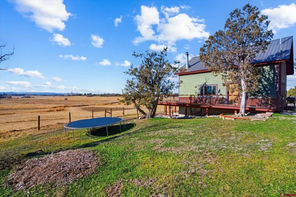 a view of a backyard with a garden and swimming pool