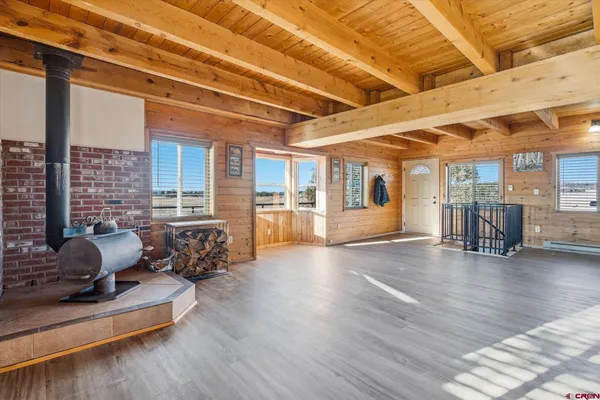 a living room with furniture and wooden floors