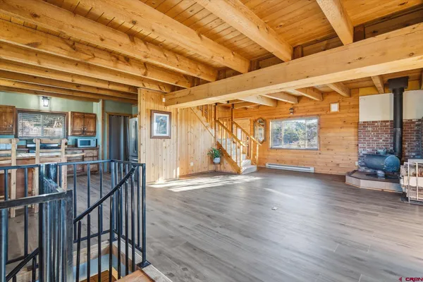 a view of an entryway with wooden floor