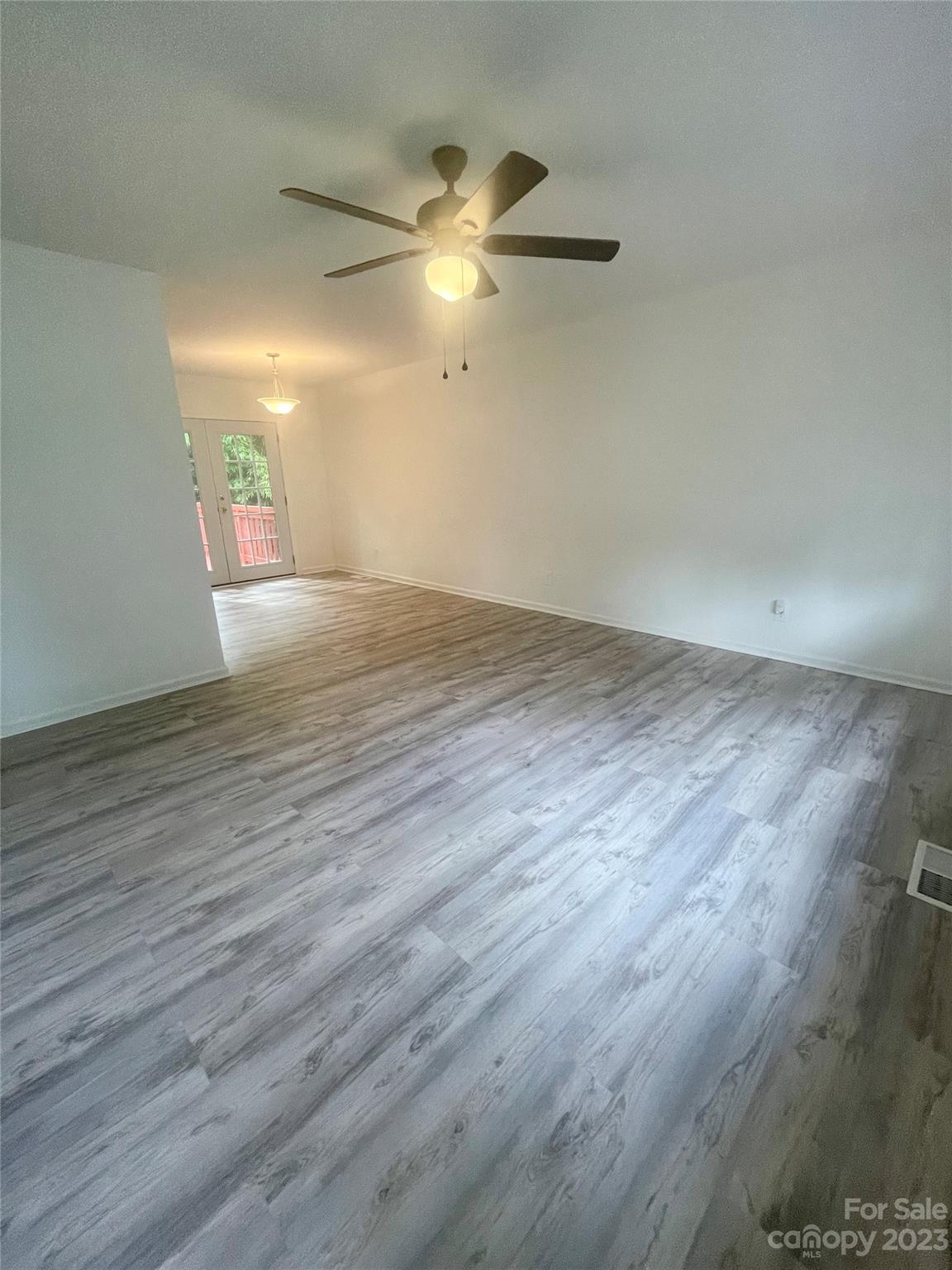 326 Finley Square Rock Hill, SC 29730 - Photo 2 of 15 an empty room with wooden floor fan and windows