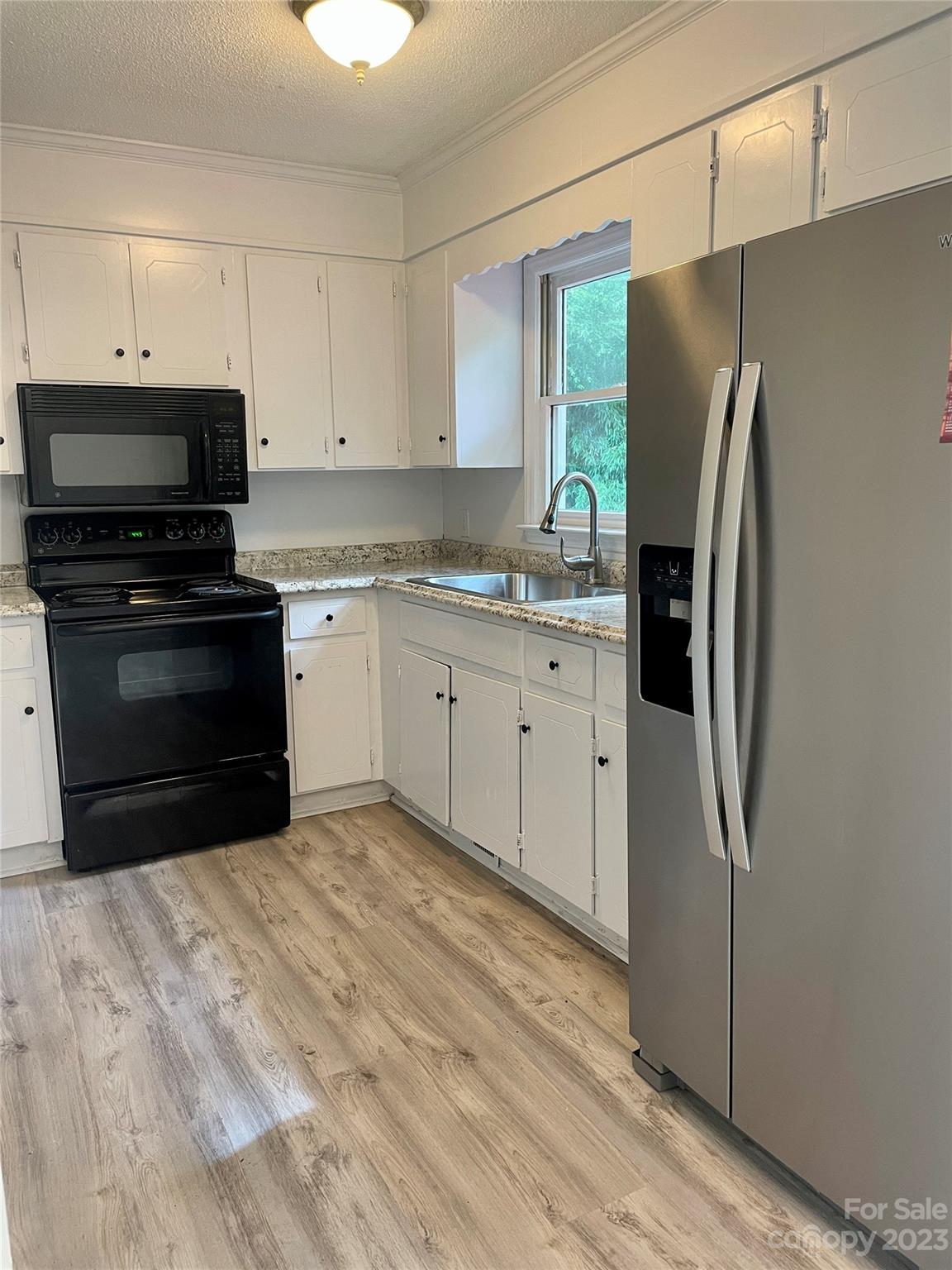 326 Finley Square Rock Hill, SC 29730 - Photo 6 of 15 a kitchen with stainless steel appliances granite countertop a refrigerator a stove a sink and a microwave