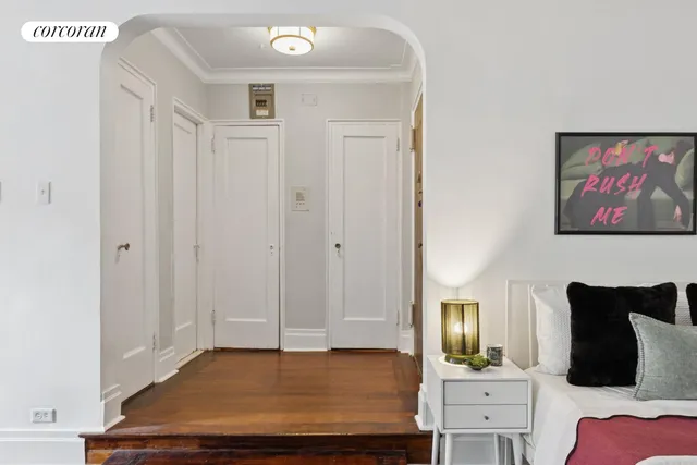 a bedroom with a bed and a potted plant