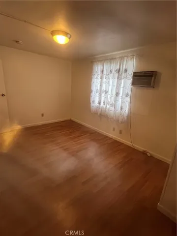 an empty room with a empty space and windows