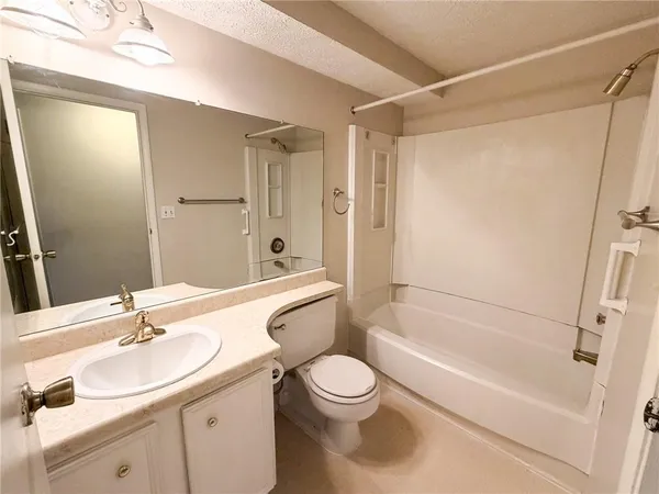 a bathroom with a sink a toilet and a bathtub