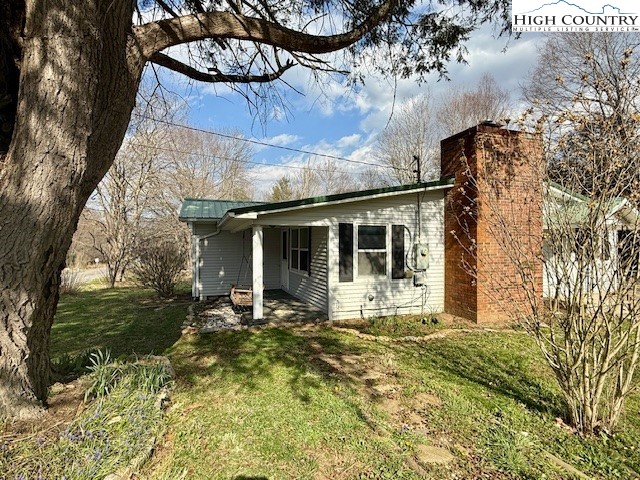 304 Elk River Road Elk Park, NC 28622 - Photo 3 of 36 a front view of a house with a yard