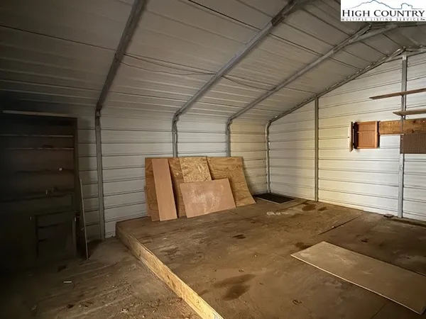 a view of backyard with cabin