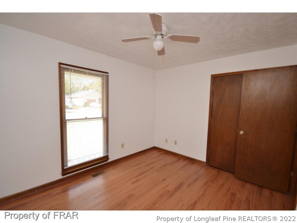 612 Jennings Farm Road Fayetteville, NC 28314 - Photo 12 of 27 an empty room with wooden floor and closet