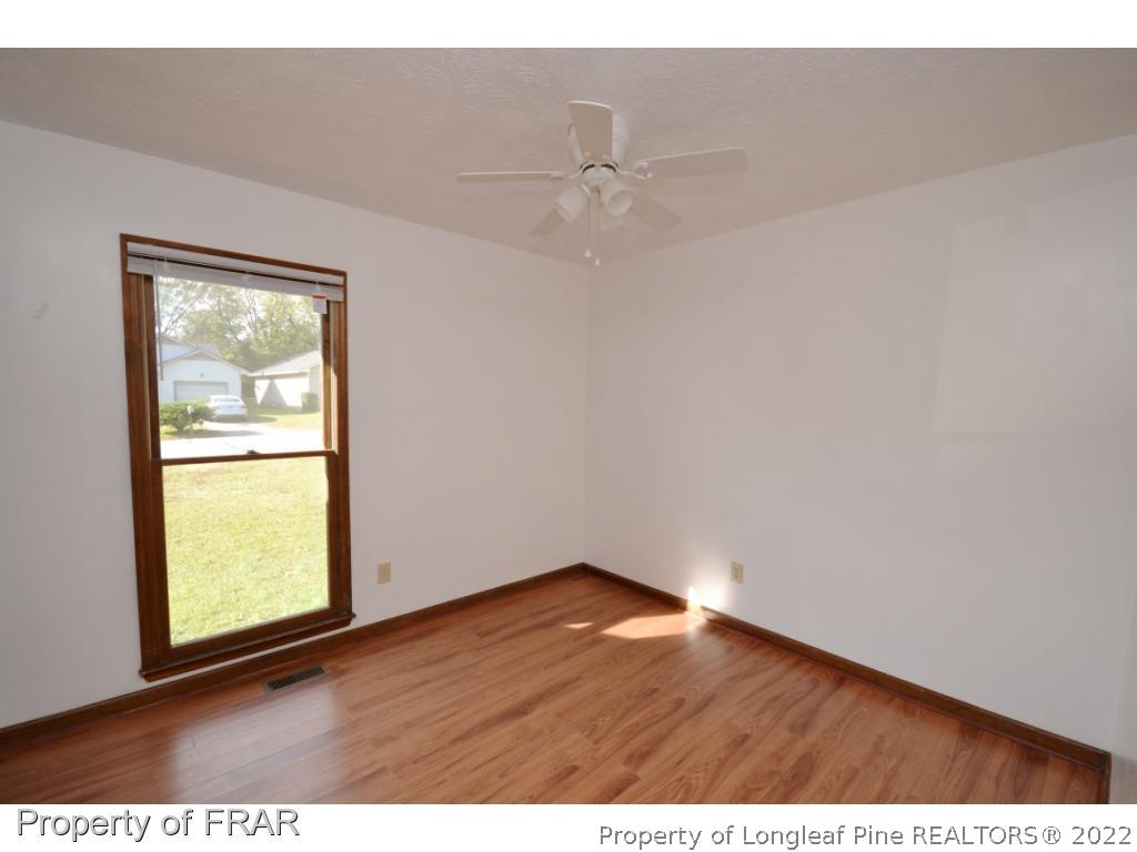 612 Jennings Farm Road Fayetteville, NC 28314 - Photo 14 of 27 an empty room with wooden floor and windows