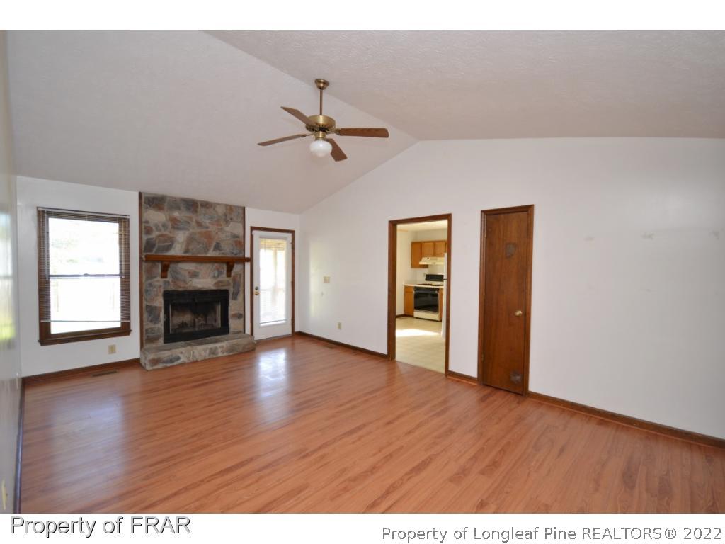 612 Jennings Farm Road Fayetteville, NC 28314 - Photo 3 of 27 a view of empty room with wooden floor and fireplace
