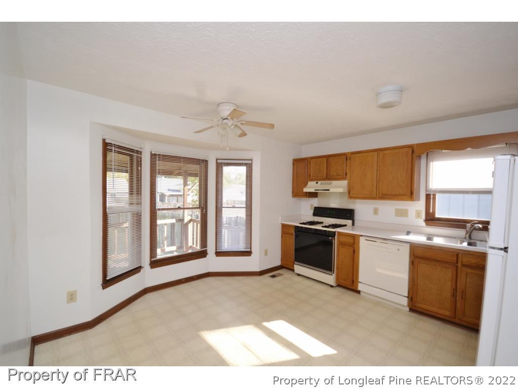 612 Jennings Farm Road Fayetteville, NC 28314 - Photo 6 of 27 a open kitchen with granite countertop a stove top oven sink and cabinets
