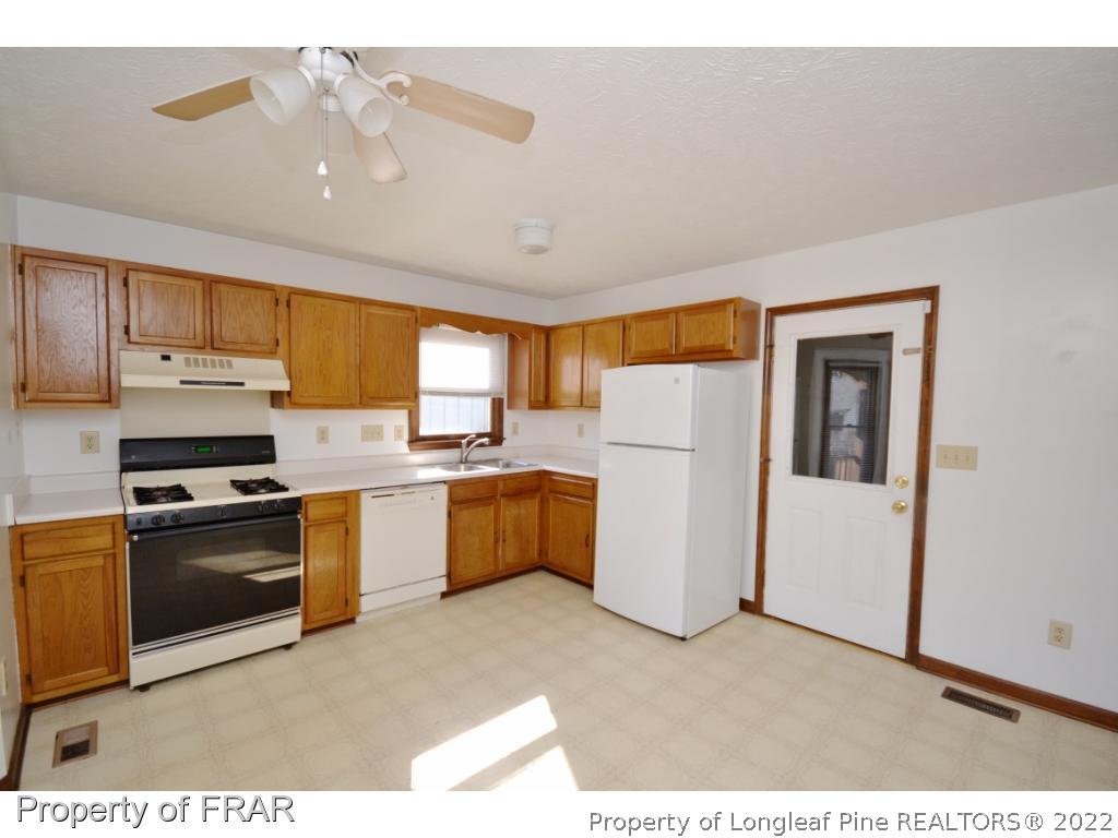 612 Jennings Farm Road Fayetteville, NC 28314 - Photo 8 of 27 a kitchen with a refrigerator and a sink