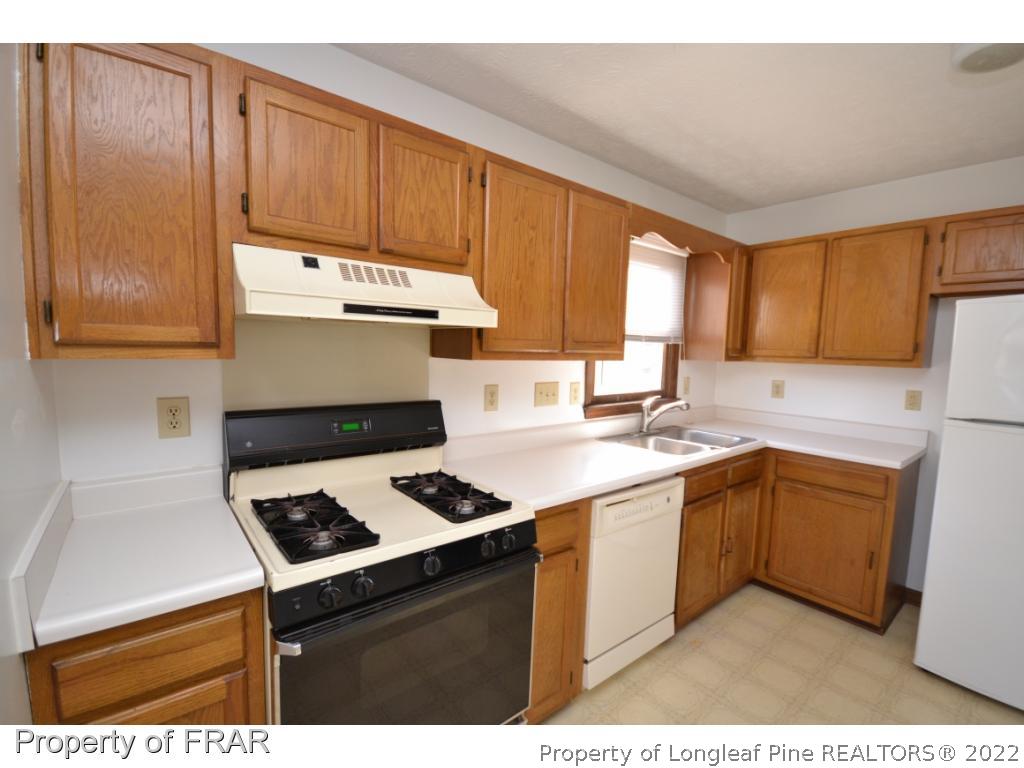 612 Jennings Farm Road Fayetteville, NC 28314 - Photo 9 of 27 a kitchen with a stove and a refrigerator