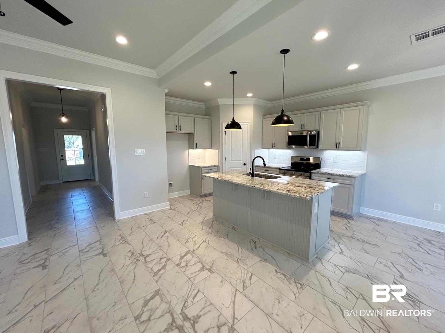 880 Sumter Loop Foley, AL 36535 - Photo 5 of 14 Kitchen with an island with sink, stainless steel appliances, crown molding, sink, and light stone counters