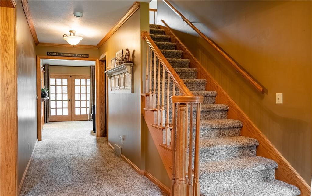 289 Nutt Road Grove City, PA 16127 - Photo 6 of 25 a view of staircase with lots of frames on wall and windows
