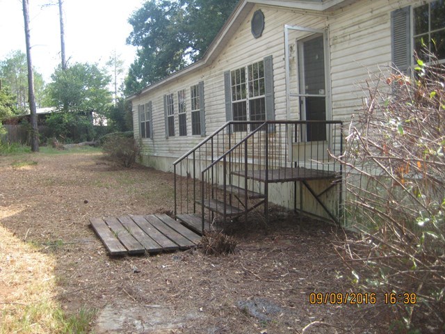 211 Orchard Road Perry, GA 31069 - Photo 3 of 7 a view of a house with backyard and a tree