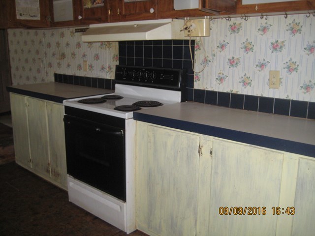 211 Orchard Road Perry, GA 31069 - Photo 7 of 7 a kitchen with a sink and a stove