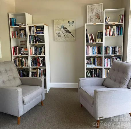 a living room with a couch and a book shelf