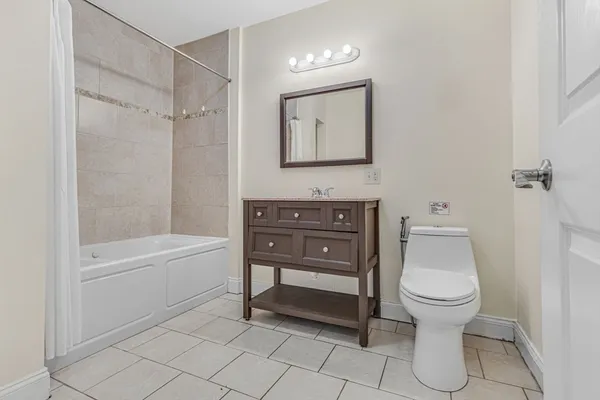 a bathroom with a toilet a sink and bathtub