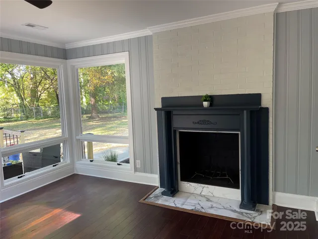 a living room with a fireplace with wooden floor
