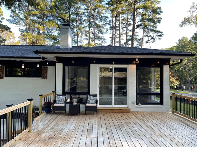 front view of a house with a large window and wooden floor