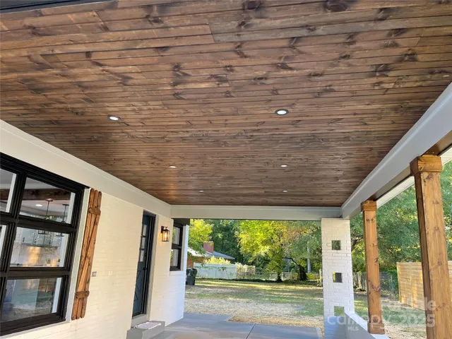 a view of a porch with wooden floor and outdoor space