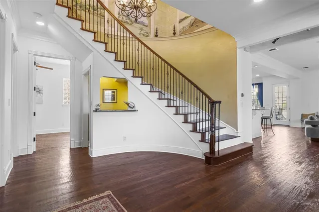 a view of entryway and hall with wooden floor
