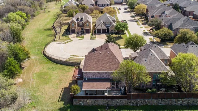 an aerial view of a house with swimming pool garden and patio