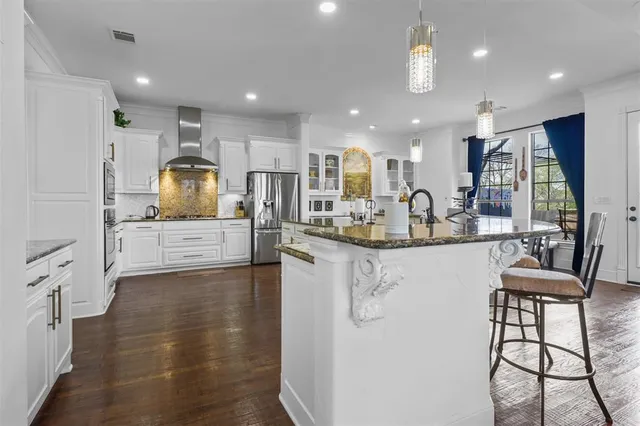a kitchen with counter top space cabinets and appliances