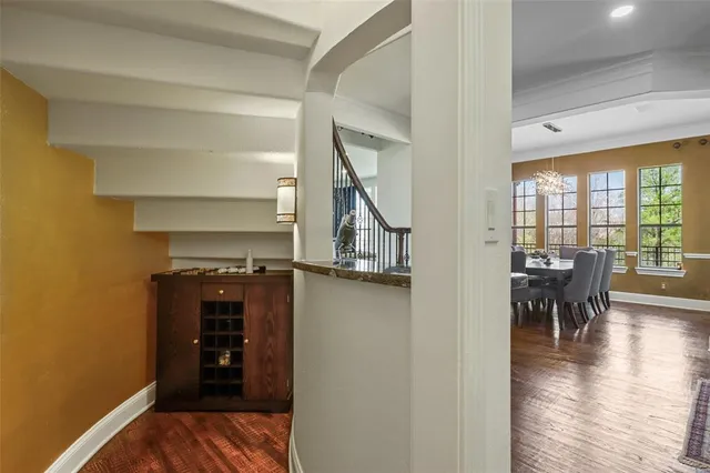 a living room with furniture a rug and a chandelier