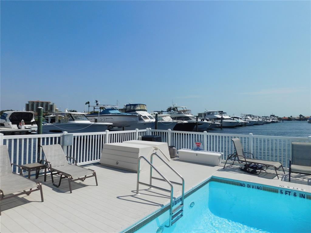 102 Riviera Dunes Way, Unit S7 Palmetto, FL 34221 - Photo 12 of 56 a roof deck with couches and wooden floor