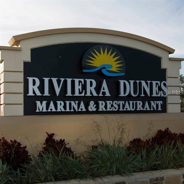 102 Riviera Dunes Way, Unit S7 Palmetto, FL 34221 - Photo 16 of 56 a street sign that is on the wall