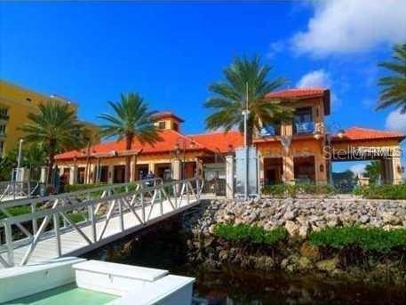102 Riviera Dunes Way, Unit S7 Palmetto, FL 34221 - Photo 5 of 56 a house with palm tree in front of it
