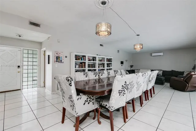 a view of a dining room with furniture and chandelier