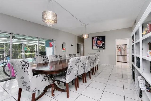 a view of a dining room with furniture and a chandelier