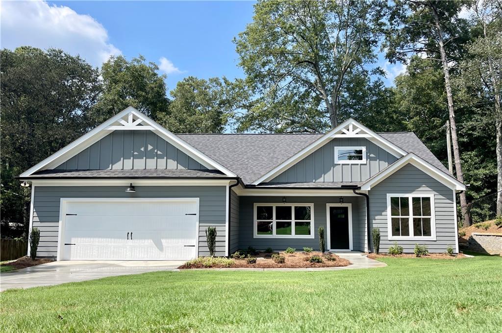 a front view of a house with a yard and porch