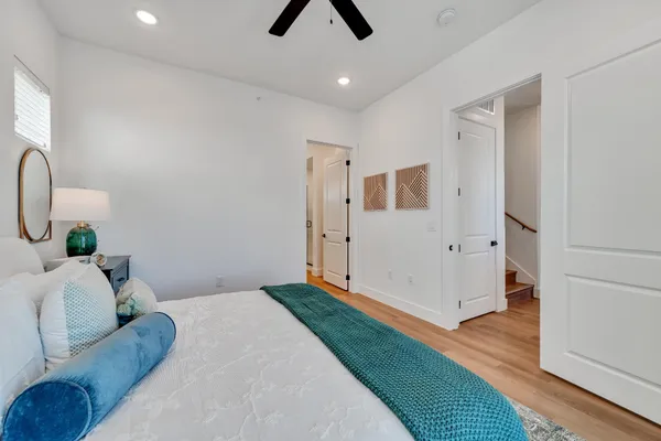 a bedroom with a bed and a chandelier