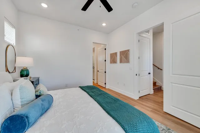 a bedroom with a bed and a chandelier