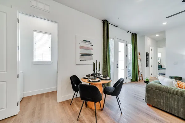 a dining room with furniture and wooden floor